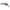 Pure silver revolver coin with engraved barrel and grip, angled side view